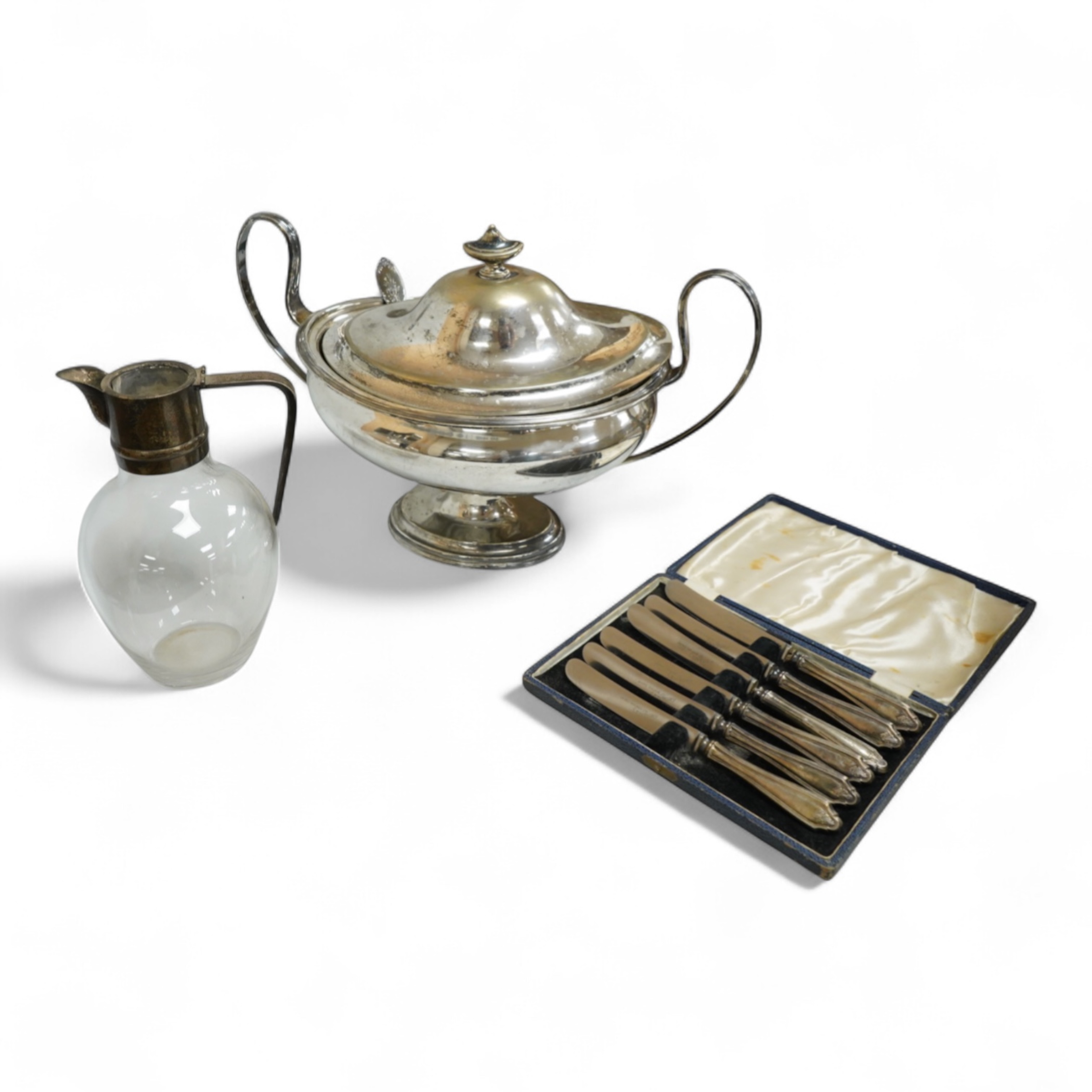 A late Victorian silver mounted claret jug (lacking cover), Holland, Son & Slater, London, 1882, height 21.1cm, together with a sterling sauce ladle, a plated two handled oval pedestal soup tureen and a cased set of six